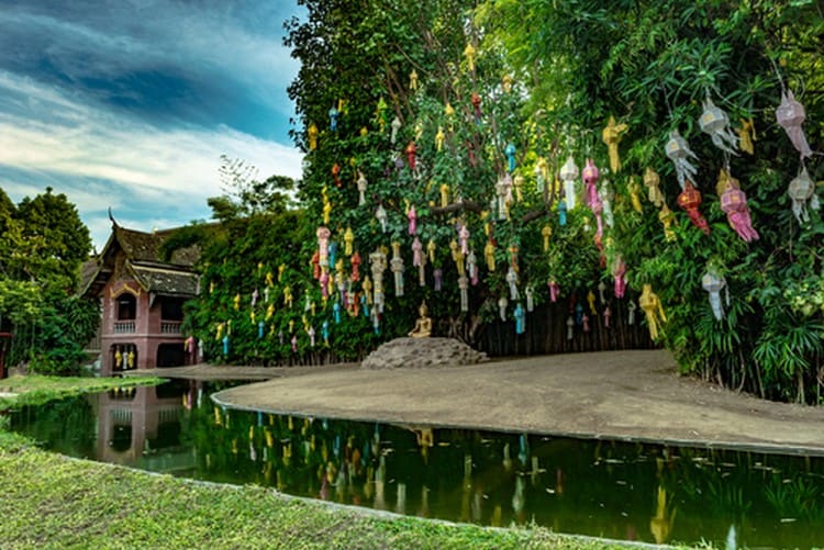 Colorful lanterns on green tree in Buddhist temple Wat Phan Tao, Chiang Mai, Thailand