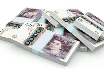 Piles of UK Money isolated on white background