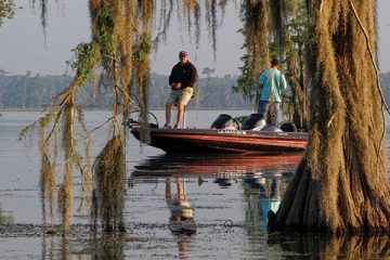 Fishermen in the morning light of the Bayou. Lake Martin, in St. Martin Parish, is a wildlife preserve and one of Louisiana swamplands.