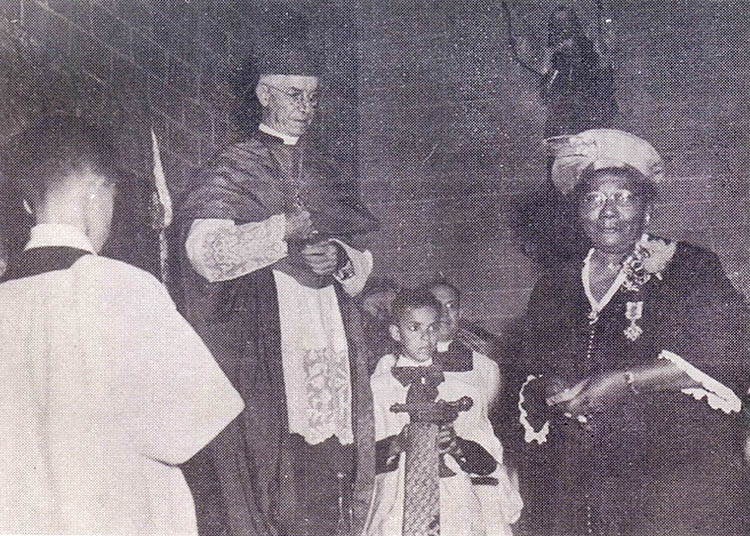 Miss Figaro - International Magazine Kreol Miss Figaro receiving the papal award from Bishop Jeanmard.
