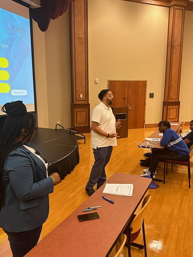 Broussard - International Magazine Kreol Brent speaking with youth about entrepreneurship at Acadiana Workforce Solutions summer camp for teens.