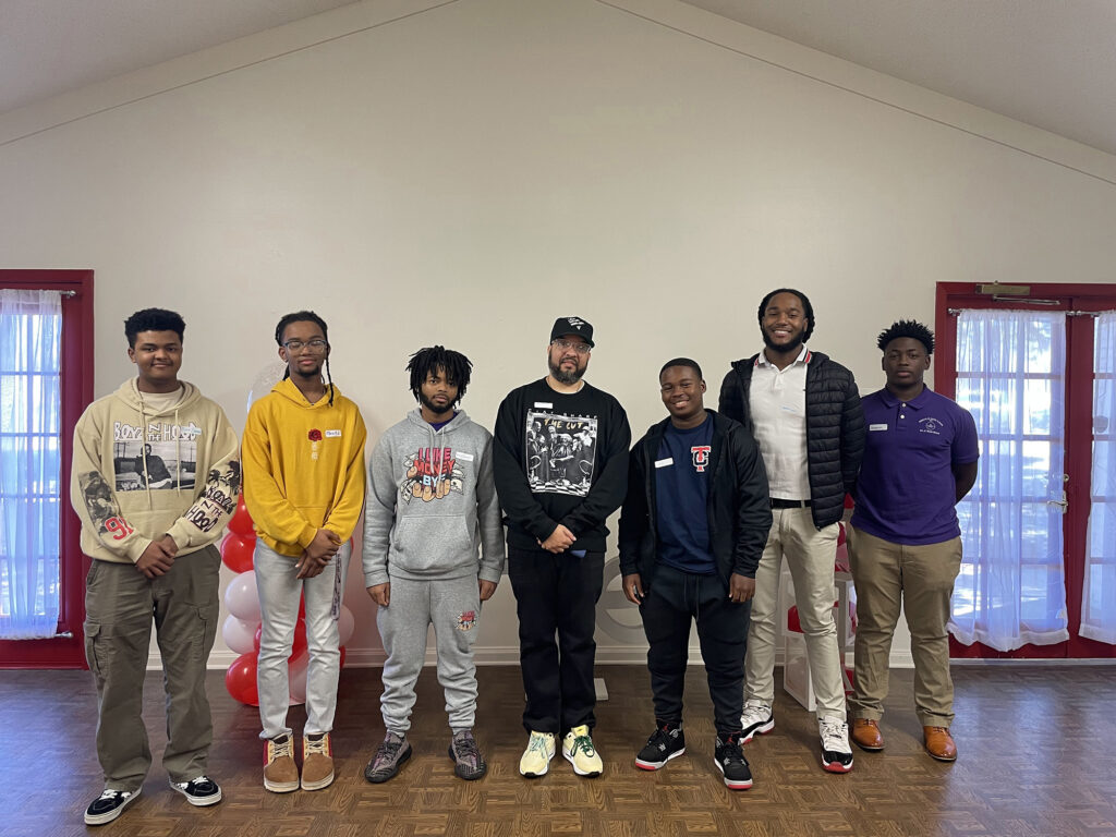 Brent P. Broussard - International Magazine Kreol Brent, alongside aspiring youths following his presentation at the Delta Sigma Theta Manhood Development workshop.