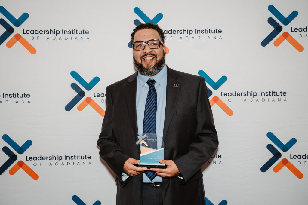 Broussard - International Magazine Kreol Brent is holding his plaque at the Leadership Lafayette Class 36 graduation celebration.