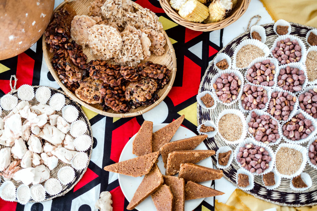 VarietyOfDeliciousDessertFromAngolaOnATableCovered - International Magazine Kreol Variety of delicious dessert from Angola on a table covered with African fabric
