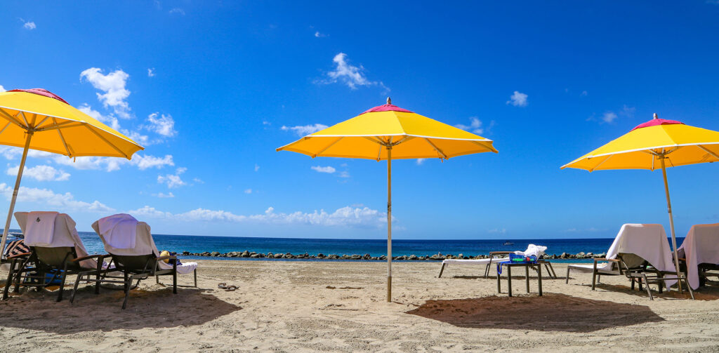 PinneysBeachUmbrellasAndChairsNevisWestIndies - International Magazine Kreol St Kitts and Nevis