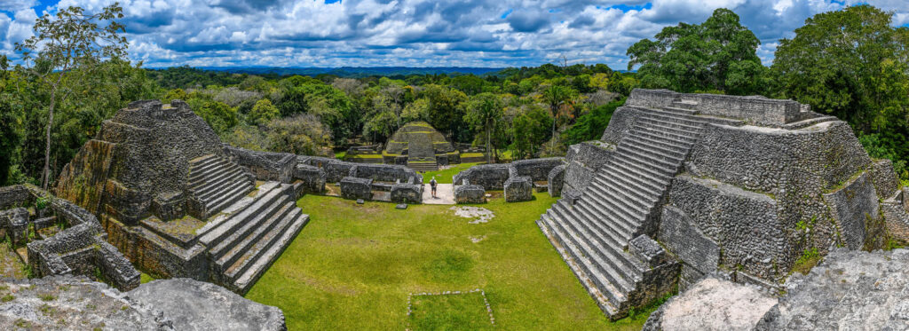 MayanPyramidOfCaanaPanoramaWithUnrecognizableTouristCaracolBelize - International Magazine Kreol Mayan Pyramid of Caana panorama with unrecognizable tourist, Caracol, Belize.