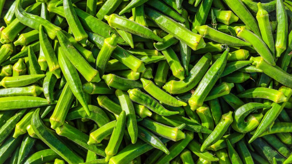 Pot - International Magazine Kreol Bundles of fresh long green beans tied with colorful strings in a woven basket.